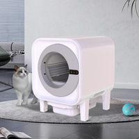 X27 smart self-cleaning cat litter box in white cube design with a Ragdoll cat sitting beside it on a grey living room rug