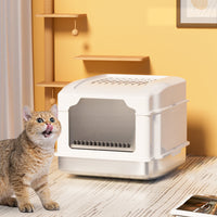 White S5 stainless steel cat litter box with a golden tabby kitten sitting beside on a wooden floor